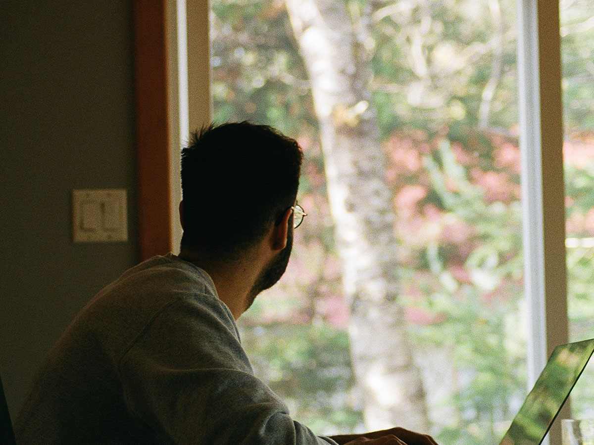 man looking out of office window