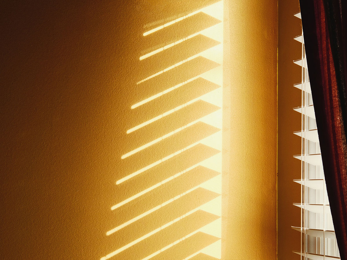 sun coming through window with open blinds